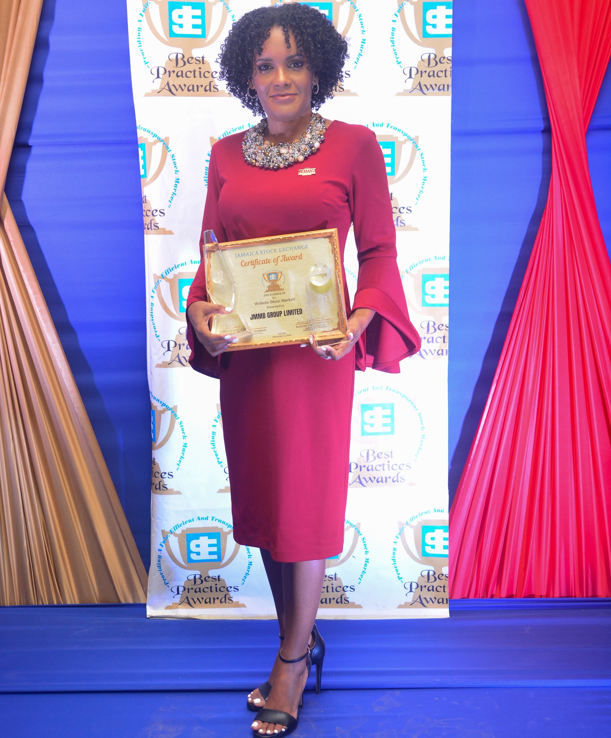 Kerry-Ann Stimpson, JMMB Group chief marketing officer shows off the three awards copped by JMMB Group at JSE Best Practices Awards Ceremony